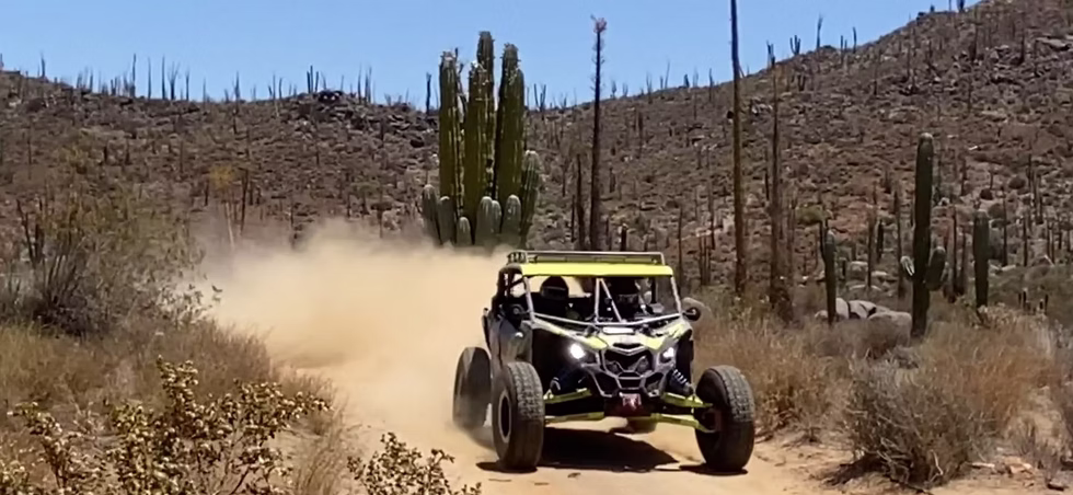 Sunset silhouette of UTV convoy on Baja off-road landscape