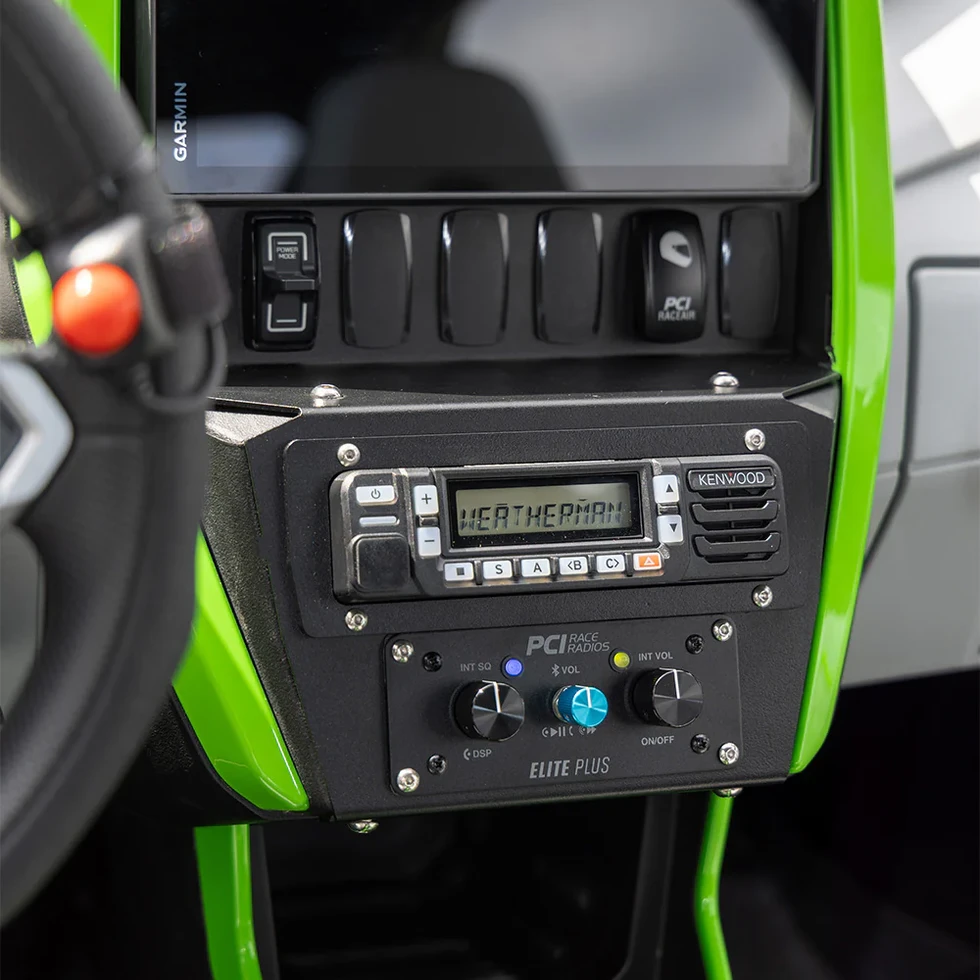 Close-up of Kawasaki Teryx H2 radio bracket showing mounting holes and hardware ready for installation