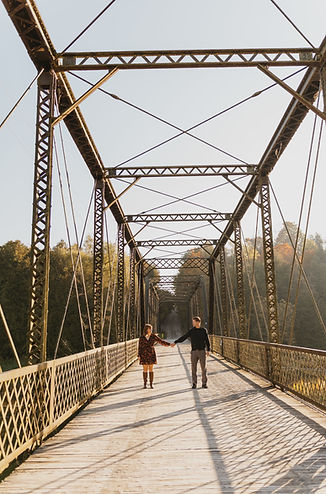 Couple holding hands on bridge