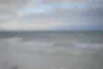 Scenic view of birds flying over the ocean at a central Florida beach.
