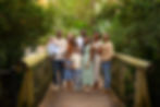 Extended family posed together on a wooden bridge in the woods during a Central Florida Vacation fam