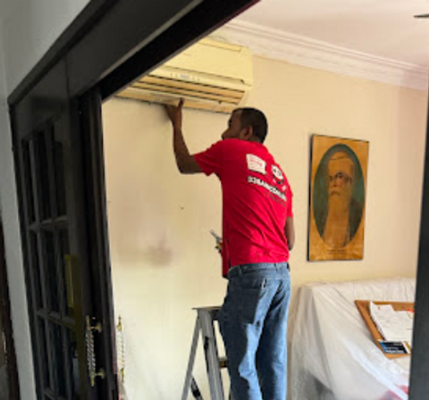 employee checking aircon