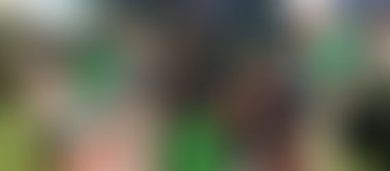 A group of teens around a YAC sign