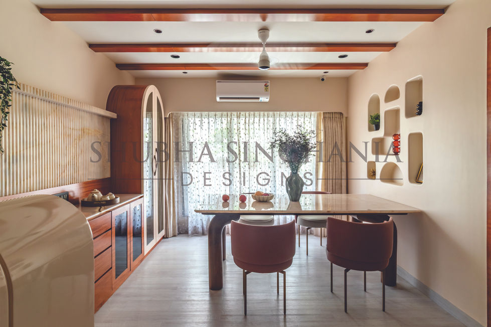 Modern dining room with wooden accents and large windows.