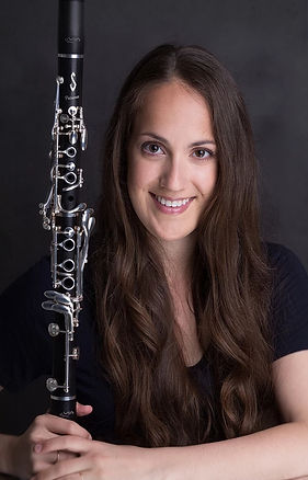 Smiling woman holding a clarinet