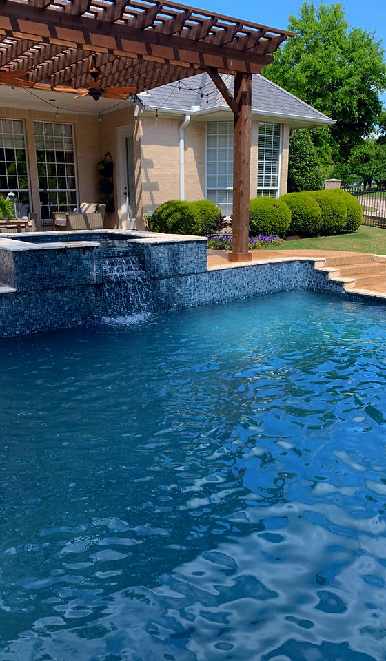 Luxury Backyard Pool with waterfall spa and wood pergola in Fort Worth residential home.