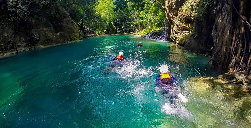 Rock Hopping and Trekking in Kawasan is an exciting outdoor adventure that involves navigating through rivers, climbing over rocks, trekking along jungle trails, and swimming in crystal-clear turquoise waters.