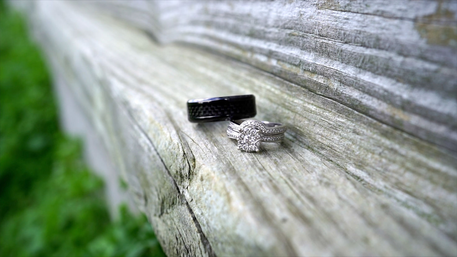 bride and groom wedding bands placed on a farm in Rochester NY