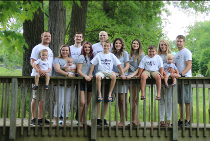 mike and family on fence.png