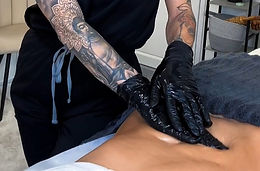 Post-op massage being performed on a models stomach during our post-operative training course