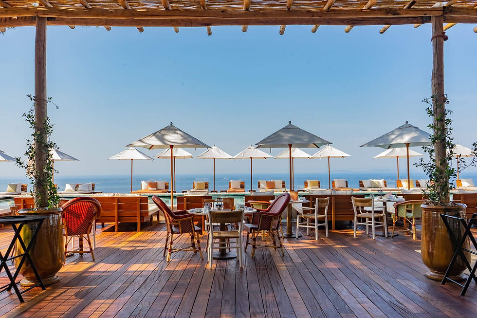 Outdoor terrace at Lily of the Valley Hotel with sea views and parasols in South of France