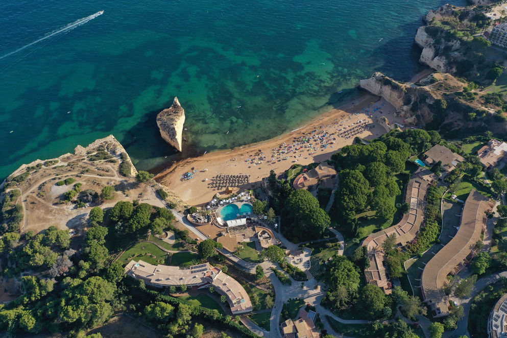 Aerial view of Vilalara Grand Hotel Algarve overlooking the beach, cliffs and turquoise coastline.