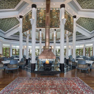 Restaurant with central fireplace and painted ceiling at Ananda