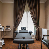 Private therapy room with wellness equipment and natural lighting.