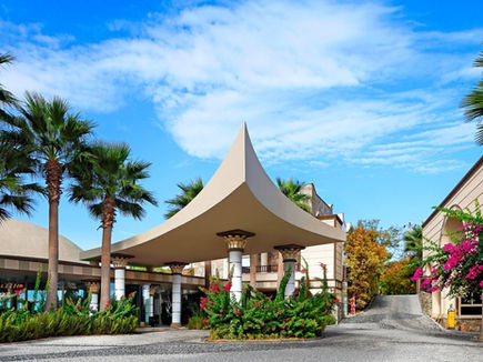 Main entrance and palm-lined driveway at Sianji Wellbeing Resort Bodrum