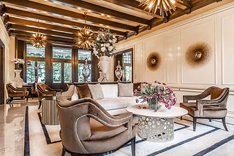 Opulent lounge with gold accents and comfortable seating at Villa Eden