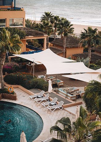 Swimming pool and shaded terrace seating at Paradis Plage Morocco resort