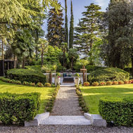 Manicured garden pathway leading to outdoor seating at Villa Eden
