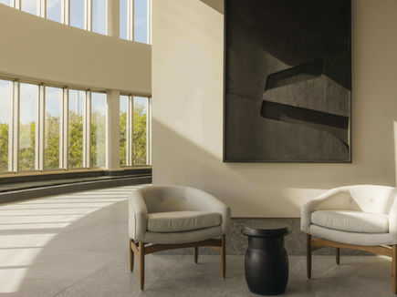 Corridor seating area at SHA Wellness Clinic Mexico with tall windows and pale stone flooring
