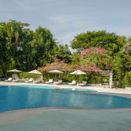 Outdoor swimming pool surrounded by tropical greenery at RXV Wellness Village Thailand