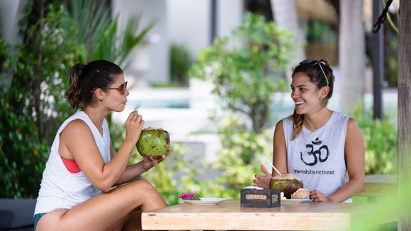 Guests enjoying fresh coconuts after yoga at Samahita Retreat