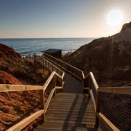 Pathway to Falésia Beach with dramatic red cliffs near Epic Sana Algarve