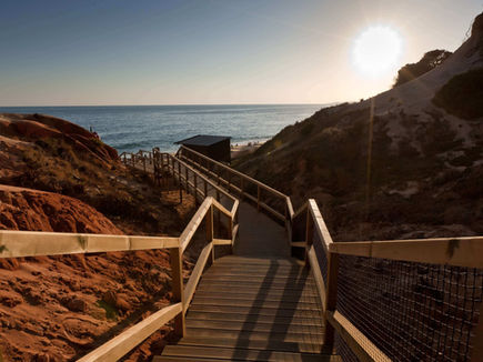 Pathway to Falésia Beach with dramatic red cliffs near Epic Sana Algarve