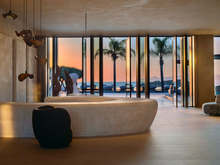 Hotel reception at Minos Palace overlooking the sea at sunrise – minimalist design with ocean views in Agios Nikolaos.