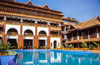 Traditional Kerala-style architecture with swimming pool at Ayursoma Ayurveda Resort.