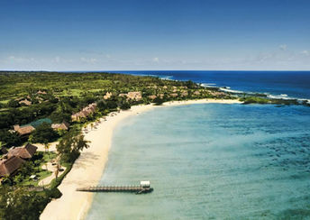 Aerial view of Shanti Maurice Resort in Mauritius, set along a white-sand beach with turquoise waters and tropical greenery