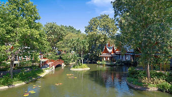 Serene lake view surrounded by gardens and traditional Thai architecture at Chiva-Som