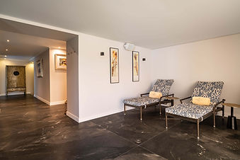 Spa relaxation lounge with reclining chairs and soft lighting