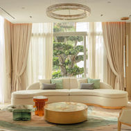 Guest lounge at ZEM Wellness Clinic Altea, with curved seating and views onto the gardens