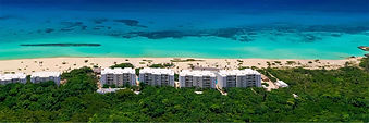 Aerial view of Palmaïa – The House of AïA in Riviera Maya with oceanfront suites overlooking turquoise Caribbean waters.