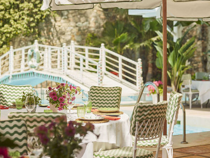 Outdoor dining terrace with floral décor at Marbella Club Hotel.