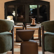 Quiet seating corner at Shanti-Som Algarve, with armchairs beside arched glass doors