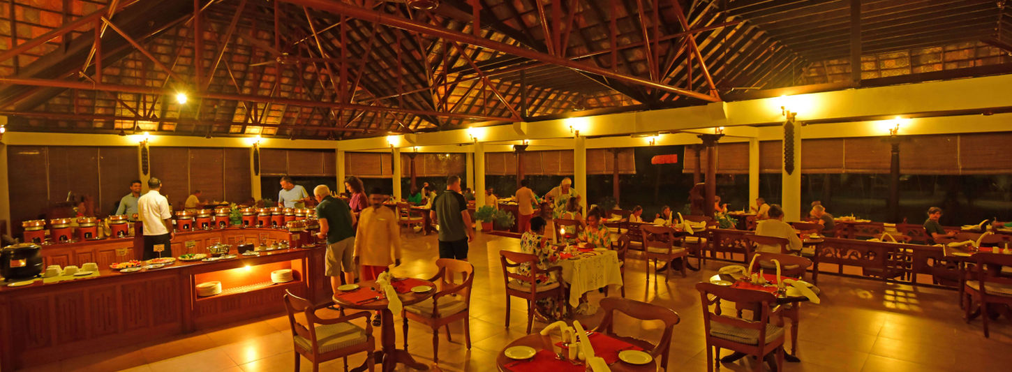 Traditional Kerala-style dining hall with evening service at Nattika Beach Kerala
