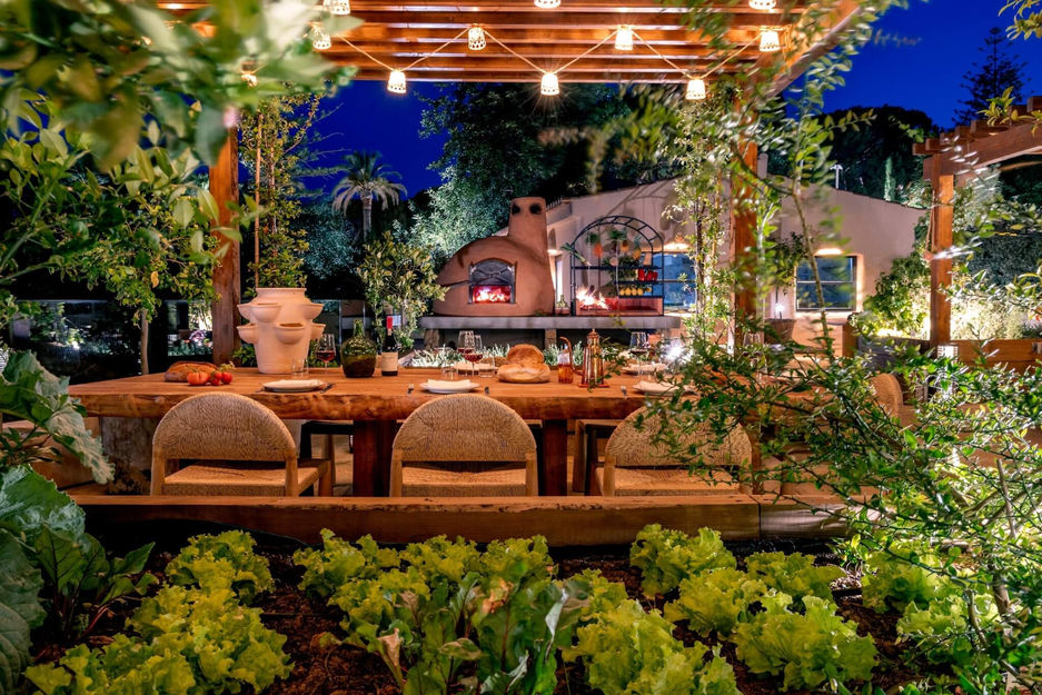 Al fresco dining at Raízes restaurant at Vilalara Grand Hotel Algarve, surrounded by greenery.