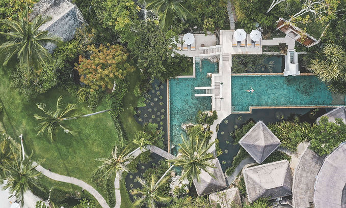 Aerial view of Kamalaya’s tranquil swimming pool surrounded by lush tropical gardens in Koh Samui