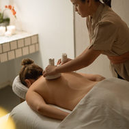 Guest receiving a back massage from a therapist in a spa treatment room