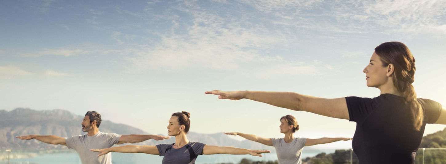 Outdoor yoga session at SHA Wellness Clinic with panoramic sea views