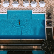 Overhead view of the swimming pool with its diamond-patterned tiled surround