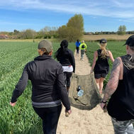 Group carrying sandbags on a countryside trail as part of GI Jane Bootcamp’s endurance training.