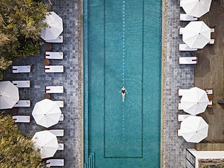 Aerial view of lap pool with umbrellas at Ananda in the Himalayas