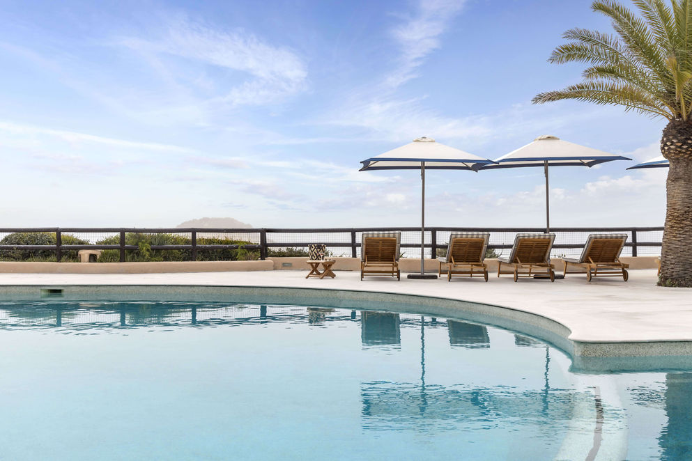 Main pool at Vilalara Grand Hotel Algarve with sun loungers and views of the Atlantic Ocean.