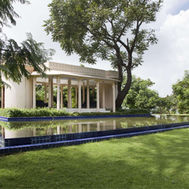 Colonnaded pavilion beside a reflecting pool in the estate gardens