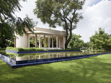 Colonnaded pavilion beside a reflecting pool in the estate gardens