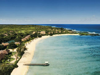 Aerial view of Shanti Maurice Resort in Mauritius, set along a white-sand beach with turquoise waters and tropical greenery