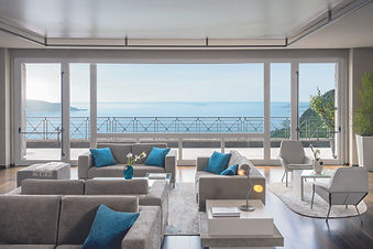 Elegant lounge area with floor-to-ceiling windows and lake views at Lefay Resort