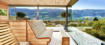 Scenic sauna with olive wood design overlooking the mountains at Preidlhof